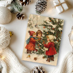 Vintage Christmas Children around tree Postcard<br><div class="desc">This design may be personalised by choosing the Edit Design option. You may also transfer onto other items. Contact me at colorflowcreations@gmail.com or use the chat option at the top of the page if you wish to have this design on another product or need assistance. See more of my designs...</div>