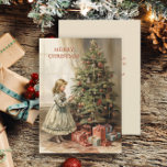 Vintage Christmas Tree Girl Gifts Holiday Card<br><div class="desc">Christmas greeting card with a vintage painting of a girl decorating a Christmas tree with wrapped gifts underneath. Text says, "Merry Christmas" but is customisable for your own greeting. Personalised on the back with your message and name. Contact me for assistance with your customisation or to request additional matching or...</div>