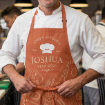 Vintage Kitchen Chef Cooking Utensil Pattern Apron<br><div class="desc">This design features a warm terracotta background with a vintage-style chef layout, including a chef hat emblem, curved kitchen text, and a scattered pattern of cooking utensils and ingredients. The hand-drawn line art of rolling pins, pans, spoons, knives, tomatoes, and lemons gives it a playful yet classic culinary feel. Its...</div>