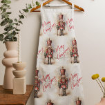 Vintage Nutcracker & Merry Christmas Apron<br><div class="desc">A beautifully illustrated vintage-style Nutcracker soldier, resplendent in his classic attire, stands tall, holding a Merry Christmas banner. The rich, warm colours and intricate details evoke a sense of yuletide nostalgia, making it a perfect choice for those who appreciate the classic holiday aesthetics. May your holiday season be filled with...</div>