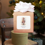 Vintage Nutcracker & Merry Christmas Square Sticker<br><div class="desc">A beautifully illustrated vintage-style Nutcracker soldier, resplendent in his classic attire, stands tall, holding a Merry Christmas banner. The rich, warm colours and intricate details evoke a sense of yuletide nostalgia, making it a perfect choice for those who appreciate the classic holiday aesthetics. May your holiday season be filled with...</div>