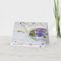 vintage pansy tea cup on fur with book