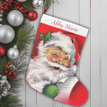 Vintage Santa Checking His List Personalised<br><div class="desc">This charming Christmas stocking beautifully captures the nostalgic essence of mid-century holiday cheer. Adorned with a delightful image of Santa Claus meticulously checking his list, this stocking harkens back to classic Christmases of yesteryear. Santa, dressed in his traditional red suit with a twinkle in his eye, exudes warmth and jollity,...</div>