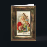 Vintage Santa Christmas Card<br><div class="desc">Charming and nostalgic image of Santa Claus busily preparing toys for Christmas. Inside is decorated with ornate filigree border. Keep suggested text or customise with your own. Matching address labels,  gift labels and postage available.
 Vintage frame graphic: studiocarilopez.com.</div>