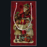 Vintage Santa Christmas Music Singing Small Gift Bag<br><div class="desc">Vintage Santa Claus Playing the Violin Santa Claus is having great fun in this reproduction of a vintage Christmas card. He's playing a violin as the two children in front of him are holding a candle, reading the sheet music, and singing along with a wonderful Christmas song. At their feet...</div>