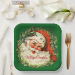 Vintage Santa Claus with Pine Wreath Christmas Paper Plate<br><div class="desc">Paper plates with a retro image featuring a smiling happy Santa Claus surrounded by a pine wreath with a sprig of holly in his cap.</div>