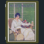 Vintage Woman with Drink in Summer Magazine Cover<br><div class="desc">This beautiful vintage illustration comes from the August 1915 issue of a woman's magazine. A woman in white sits on a wicker chair holding a fan and a cool drink. A green shade is behind her. Very summery looking!</div>