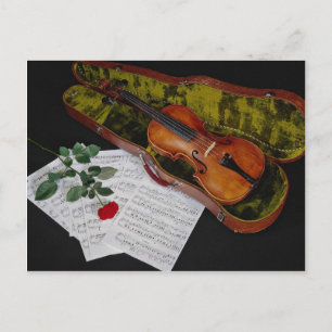 Violin and red rose on black background postcard
