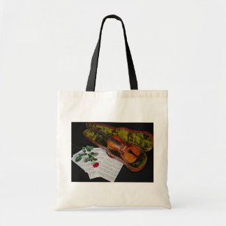 Violin and red rose on black background tote bag