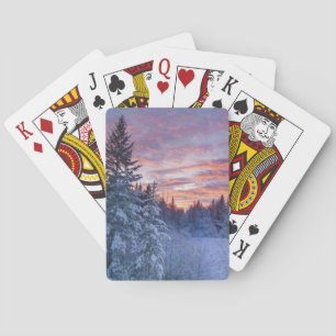 Vivid sunset paints the sky above wintery playing cards