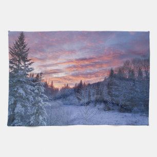 Vivid sunset paints the sky above wintery tea towel