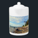 Vormsi Stillness Teapot<br><div class="desc">This artwork captures the quiet strength and timeless presence of Vormsi, a small Estonian island in the Baltic Sea. At its center stands the Saxby Lighthouse — not as a symbol of grandeur, but as a calm, steady guide surrounded by coastal silence. The composition draws on soft natural tones, minimal...</div>