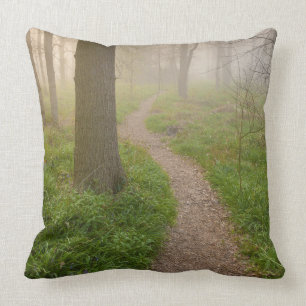 Walking path leading into a forest throw pillow