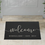 Warm Welcome | Modern Calligraphy Personalised Doormat<br><div class="desc">A great gift for newlyweds or new homeowners,  our personalised welcome doormat in chic and durable black features "welcome" in modern,  elegant handwritten calligraphy script. Personalise with your family name and year established in classic block lettering.</div>