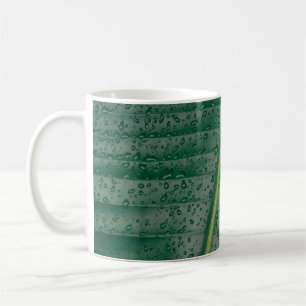 Water droplets on banana leaf coffee mug