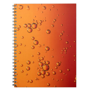 Water droplets on orange surface notebook