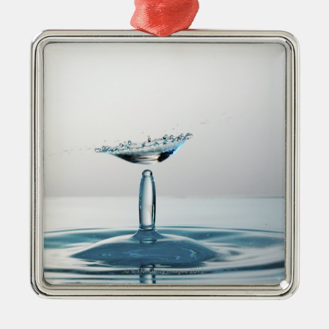 Water drops colliding to shape an umbrella metal tree decoration (Front)