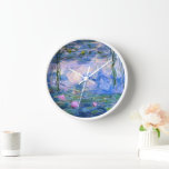 Water Lilies Clock<br><div class="desc">Water Lilies is a series of over 200 oil paintings by French Impressionist Claude Monet. This beautiful wall clock features one of those colourful paintings. It features a pond with water lily flowers in shades of blue and pink.</div>