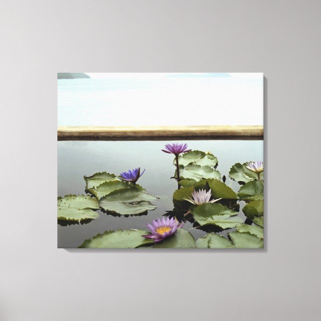 Water lilies in pond by ocean canvas print (Front)