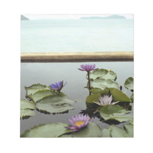 Water lilies in pond by ocean notepad