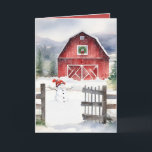 Watercolor Christmas Barn And Snowman Holiday Card<br><div class="desc">Red barn with green Christmas wreath,  snowman,  and rustic old fence in snowflakes.</div>