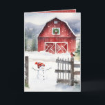 Watercolor Christmas Barn With Snowman Holiday Card<br><div class="desc">Red barn with a green Christmas wreath,  a snowman,  and a bird wearing a winter scarf on an old fence in snowflakes.
Text can be edited.</div>