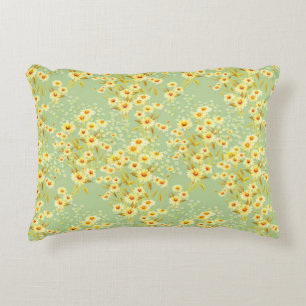 Watercolor picture of daisy flowers on a light gre decorative cushion
