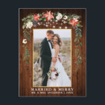 Watercolor Winter Floral Wood Gold Married Merry Postcard<br><div class="desc">Rustic Wood Elegant Watercolor Winter Floral Wood Newlywed Photo Married & Merry Christmas Postcard includes beautiful watercolor red poinsettias,  botanical greenery,  winter foliage,  holly berries,  white roses,  cotton,  pine cones and blue berries.  Rustic Country Wood and String Lights. Gold Frame.</div>