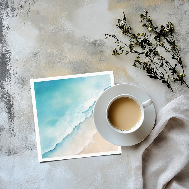 Watercolour beach sand and blue sea napkin (A napkin with a watercolor image of a sandy beach and light blue ocean)