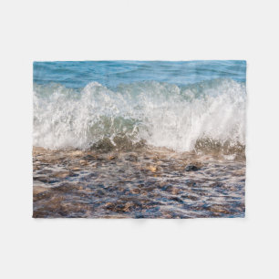Wave breaking on rocky shore in Michigan Fleece Blanket