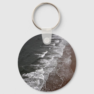 Waves breaking on a sandy beach key ring