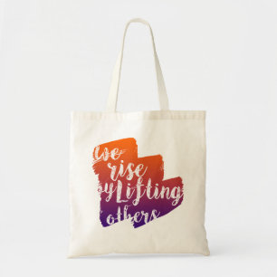 We rise by lifting others tote bag