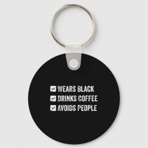 Wears black drinks coffee avoids people  key ring