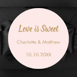 Wedding blush gold names Love is Sweet Classic Round Sticker<br><div class="desc">Blush pink background. Text: Love is Sweet.  Personalise and add your names and the wedding date. 

For sweet guest favours like chocolate,  cookies.</div>
