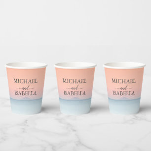 Wedding by the sea under peachy sky sunset paper cups
