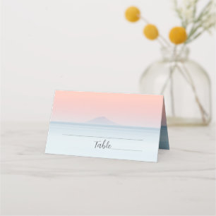 Wedding by the sea under peachy sky sunset place card