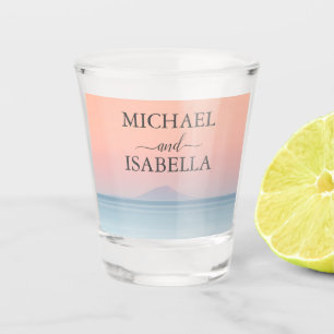 Wedding by the sea under peachy sky sunset shot glass