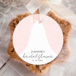 Wedding Dress Pink Bridal Shower Classic Round Sticker<br><div class="desc">Elegant,  stylish stickers are perfect bridal shower stickers featuring a beautiful modern wedding gown on a white rose pattern over a pink background and your details in chic lettering - use for party favours or thank you stickers. MORE colours and MATCHING invitations and more in our store.</div>