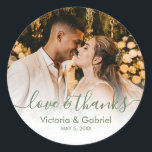 Wedding Photo Green White Script Photo Thank You Classic Round Sticker<br><div class="desc">Modern Pretty Sage Green White Calligraphy Script Thank You | Couple Photo Wedding sticker/label for yor gift favour. Featuring an elegant handwritten style calligraphy overlay with text „Love and Thanks”.</div>
