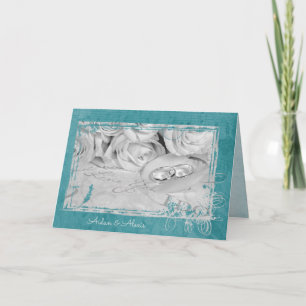 wedding rings on rose petal card