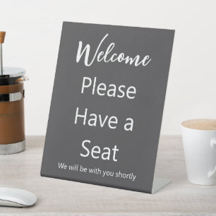 Welcome Please Have a Seat Grey and White Text Pedestal Sign