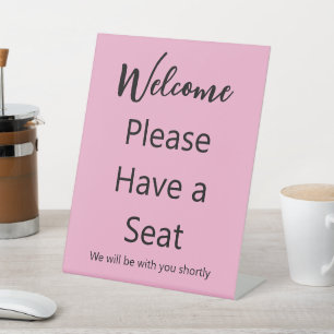 Welcome Please Have a Seat Pink and Black Text Pedestal Sign