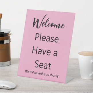 Welcome Please Have a Seat Pink and Black Text Pedestal Sign