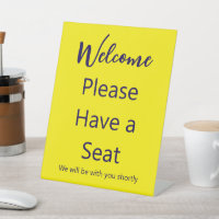 Welcome Please Have a Seat Yellow and Blue Text