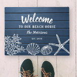 Welcome to Our Beach House Family Name Custom Doormat<br><div class="desc">Greet visitors to your beach house with this super cute door mat featuring vintage shells set against a nautical blue wood-style background.  Add 4 lines of custom text to personalise.  Perfect for a beach house,  vacation rental,  seaside cottage - makes a wonderful housewarming gift too.</div>