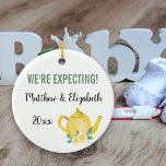 We're Expecting A Baby is Brewing Personalised Ceramic Tree Decoration<br><div class="desc">Pretty ornament for your pregnancy which you can personalise. One side has yellow flowers and hand lettered script typography which reads "A baby is brewing". The other side has a cute yellow teapot and your custom text. The template is set up for you to edit the sample wording which reads...</div>