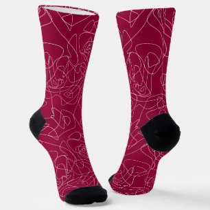 White abstract doodles on dark red background socks