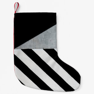 White and black diagonal striped paint on wall small christmas stocking