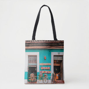 WHITE BICYCLE PARKED BESIDE TEAL PAINTED CONCRETE TOTE BAG