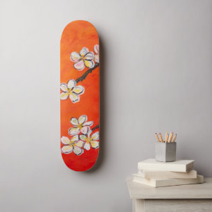 White blossoms on orange red spring background skateboard